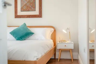 a bedroom with a bed with a blue pillow and a nightstand at 1 Bed in Looe oc-s29019 in Looe