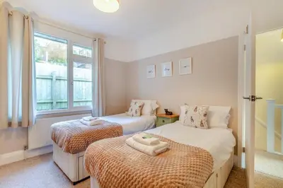 a bedroom with two beds and a window at 3 Bed in Looe oc-s29266 in Looe