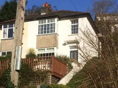 a large white house with a man on top of it at 3 Bed in Looe oc-s29266 in Looe