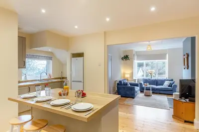 a kitchen and living room with a table with plates on it at 3 Bed in Looe oc-s29266 in Looe