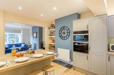 a kitchen with a table with chairs and a counter top at 3 Bed in Looe oc-s29266 in Looe