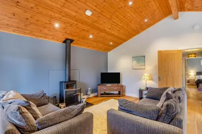a living room with two couches and a flat screen tv at 2 Bed in Winnards Perch oc-s29311 in Saint Columb Major
