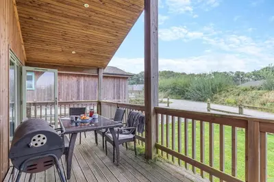a patio with a table and chairs on a deck at 2 Bed in Winnards Perch oc-s29311 in Saint Columb Major