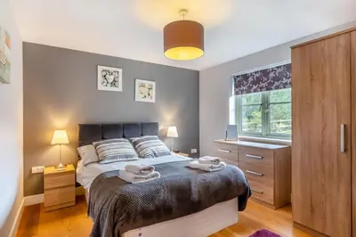a bedroom with a bed with two towels on it at 2 Bed in Winnards Perch oc-s29311 in Saint Columb Major
