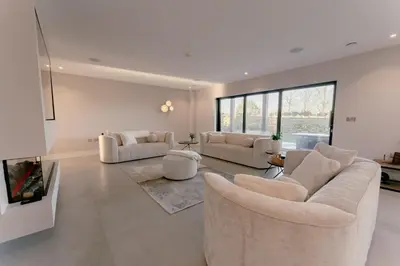 a living room with two couches and a fireplace at Luxury holiday home with HOT TUB in St Merryn