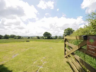 a wooden fence in a field with a field behind it at Rowan in Launceston