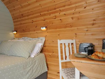 a bedroom with a bed and a wooden wall at Rowan in Launceston