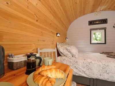 a room with a bed and a table with bread on it at Hornbeam in Launceston