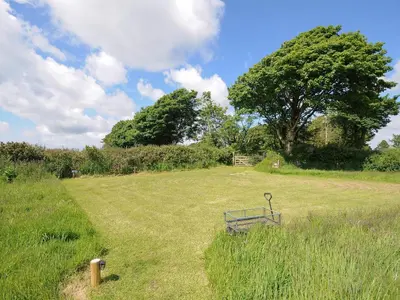 a bench sitting in the middle of a field at Hornbeam in Launceston