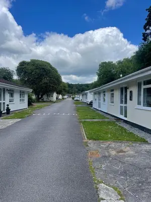 an empty street with white buildings on either side at Beekeepers Cottage in Liskeard