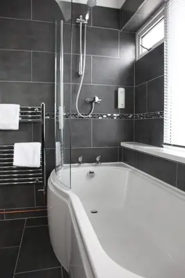 a bathroom with a bath tub and a shower at Best Western Fowey Valley in Lostwithiel