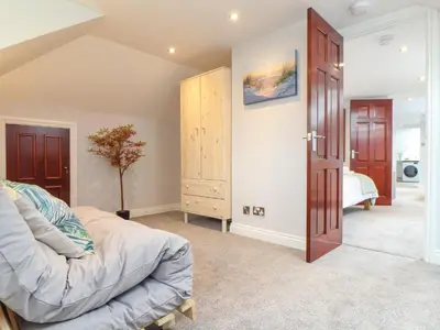 a bedroom with a bed and a closet in a room at Squirrels Leap in Falmouth