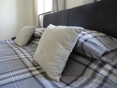 a bed with two pillows on top of it at Tidal Heights in Padstow