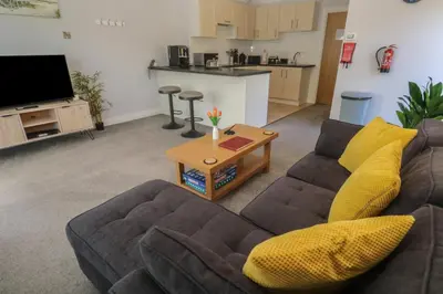 a living room with a couch and a table at Lake View in Falmouth