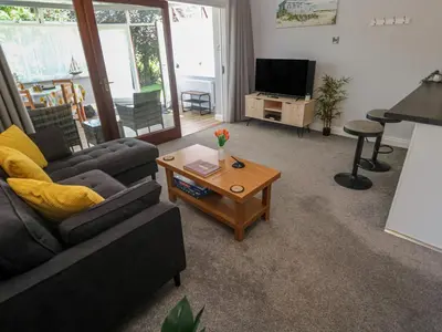 a living room with a couch and a coffee table at Lake View in Falmouth
