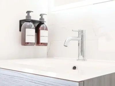 a bathroom sink with two soap bottles on the wall at Lake View in Falmouth