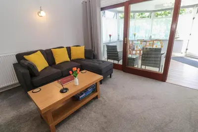 a living room with a couch and a coffee table at Lake View in Falmouth
