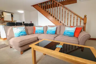 a living room with a couch with pillows on it at Ebrenn in Tintagel