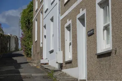 a row of white houses on a street at Mount Pleasant, St Ives in St Ives
