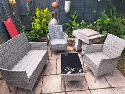 three wicker chairs and a table in a garden at Willow Bungalow Quiet and secluded in Carbis Bay