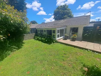 a small house with a lawn in front of it at Willow Bungalow Quiet and secluded in Carbis Bay