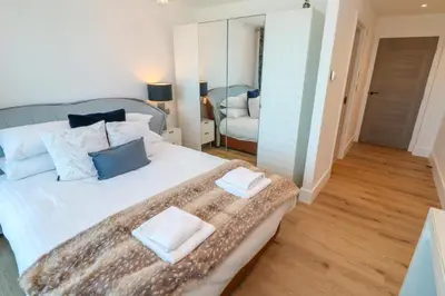 a bedroom with a large bed with two towels on it at 17 Cliff Edge in Newquay