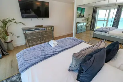 a bedroom with two large beds and a dresser at 17 Cliff Edge in Newquay