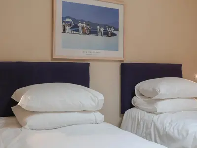 a bedroom with two beds and a picture on the wall at Blue Vista in Carbis Bay
