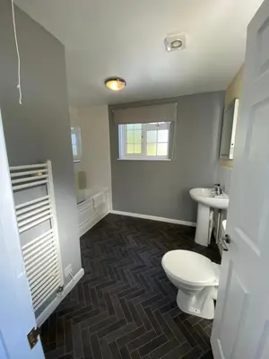 a bathroom with a toilet and a sink at Jubilee Inn in Looe