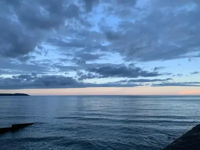 a view of the ocean under a cloudy sky at Fowey, Cute Cottage in Fowey