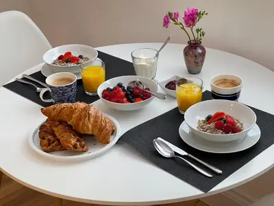 a white table with breakfast foods and drinks on it at Guest Room with Parking Near St Ives & Penzance in Penzance