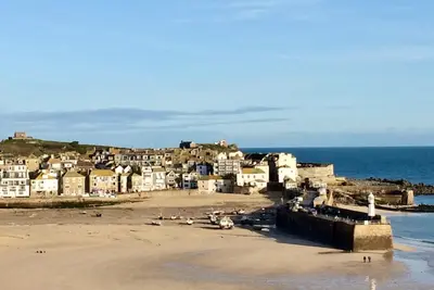 a view of a beach with houses and the ocean at Guest Room with Parking Near St Ives & Penzance in Penzance