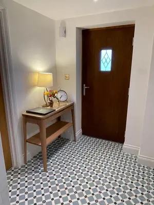 a hallway with a desk and a door with a window at Guest Room with Parking Near St Ives & Penzance in Penzance