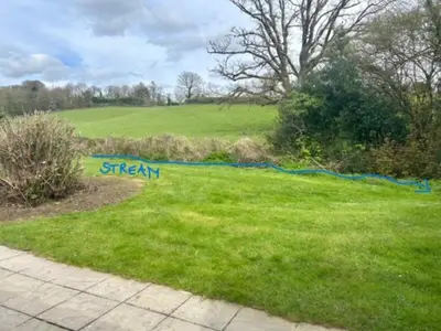 a yard with a sign in the grass at Rosecraddoc Lodge 23 in Liskeard