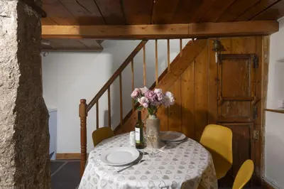 a table with a vase of flowers on it at Cosy Cottage in St Ives, Wi-Fi, Pets Accepted in St Ives