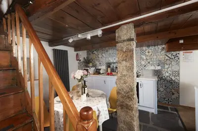 a kitchen with a table and a dining room at Cosy Cottage in St Ives, Wi-Fi, Pets Accepted in St Ives