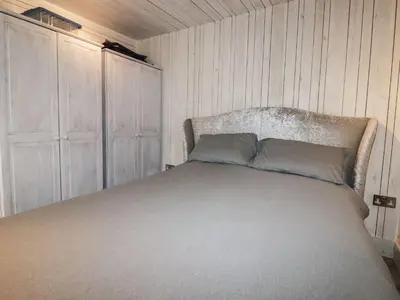 a bedroom with a bed with two pillows on it at Villa 18 Lanteglos Holiday Park in Camelford