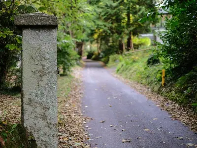 a stone pillar on the side of a road at Villa 18 Lanteglos Holiday Park in Camelford