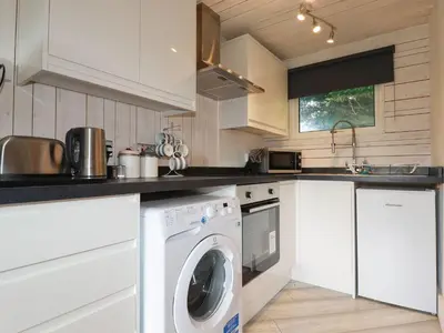 a kitchen with a washer and dryer at Villa 18 Lanteglos Holiday Park in Camelford