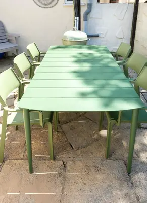 a green dining table with chairs around it at Spacious Farmhouse between St Agnes & Porthowan in Truro