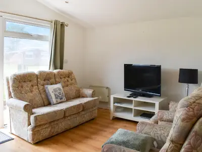 a living room with a couch and a flat screen tv at Mother Ivy's Bay - Uk47553 in St Merryn