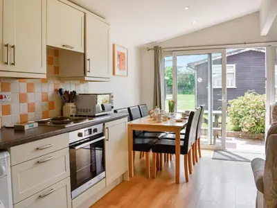a kitchen with a table and a dining room at Mother Ivy's Bay - Uk47553 in St Merryn