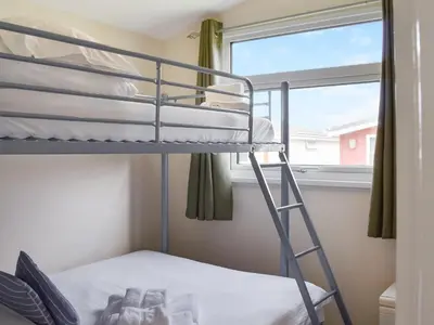 a bunk bed in a room with a window at Mother Ivy's Bay - Uk47553 in St Merryn