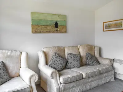 a couch and two chairs in a living room at Trevose Head - Uk47556 in St Merryn