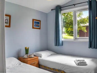two beds in a room with a window at Trevose Head - Uk47556 in St Merryn