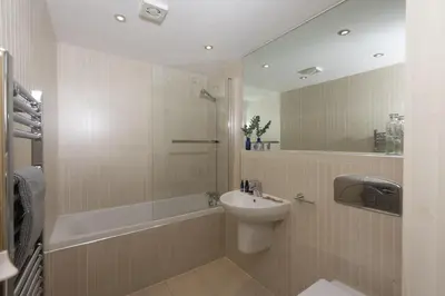 a bathroom with a sink and a shower and a toilet at Apartment By The Sea, Wi-Fi, Pets Accepted in St Ives
