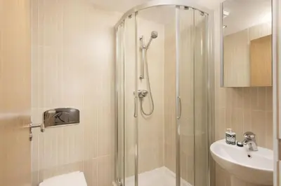 a bathroom with a shower and a toilet and a sink at Apartment By The Sea, Wi-Fi, Pets Accepted in St Ives