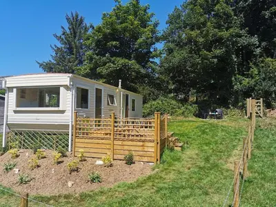 a tiny house in a yard with a fence at Meadow Bluebird in Bodmin