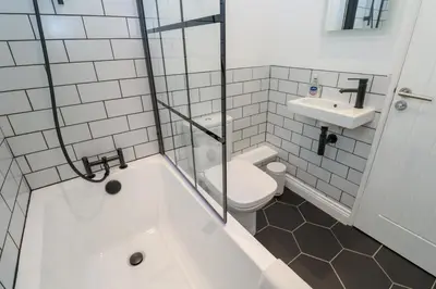 a bathroom with a tub and a toilet and a sink at St Piran in St Ives