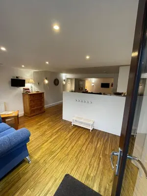 a living room with a couch and a table at No1 Apartment Mevagissey in Mevagissey